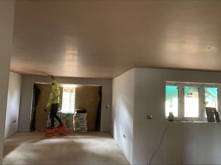Freshly boarded and skimmed ceiling in a large open room